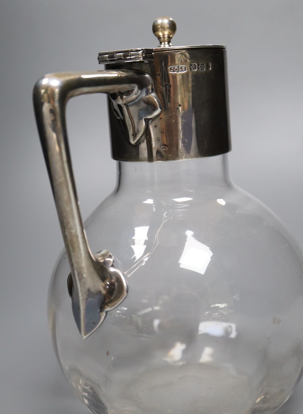 A late Victorian silver-mounted glass globular claret jug in the style of Christopher Dresser, Sheffield, 1897